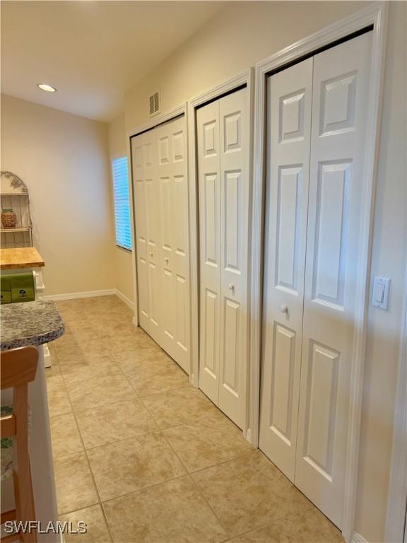 hall featuring light tile patterned flooring