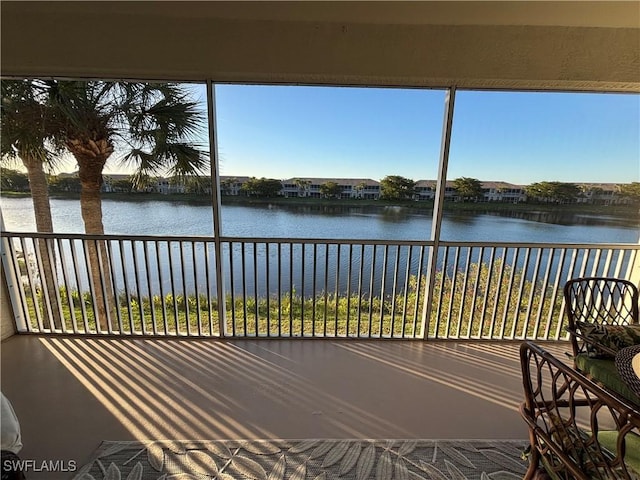 unfurnished sunroom featuring a water view and a healthy amount of sunlight