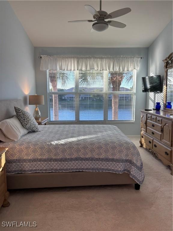 bedroom featuring ceiling fan and light colored carpet