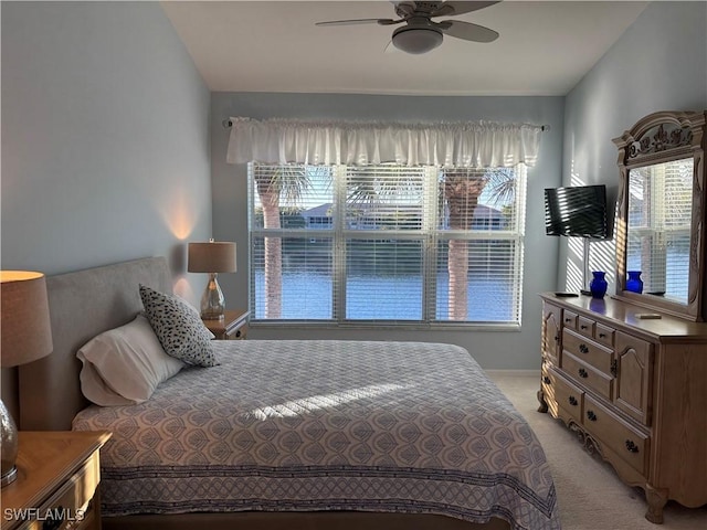 bedroom with light carpet and ceiling fan