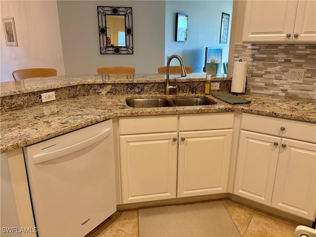 kitchen with white cabinetry, sink, tasteful backsplash, kitchen peninsula, and white dishwasher