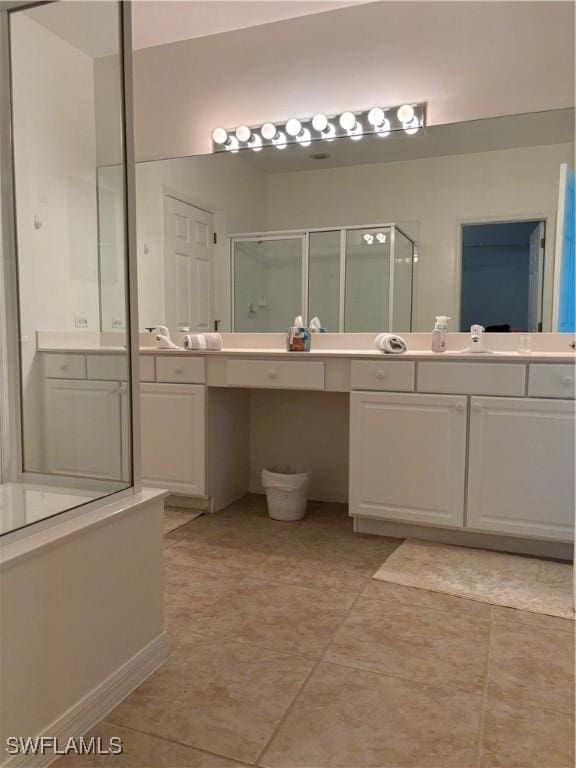 bathroom with tile patterned flooring, vanity, and a shower with shower door