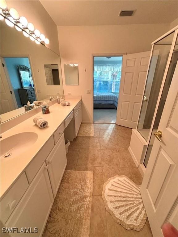 bathroom with vanity, tile patterned floors, and a shower with shower door