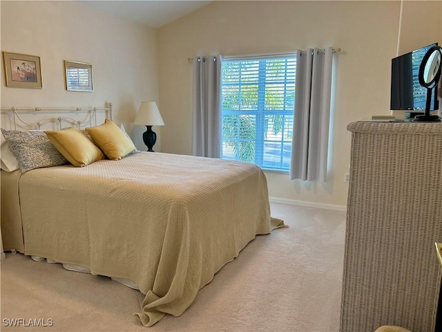 carpeted bedroom featuring lofted ceiling