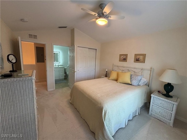 carpeted bedroom with lofted ceiling, electric panel, ensuite bathroom, ceiling fan, and a closet