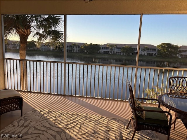 sunroom / solarium with a water view