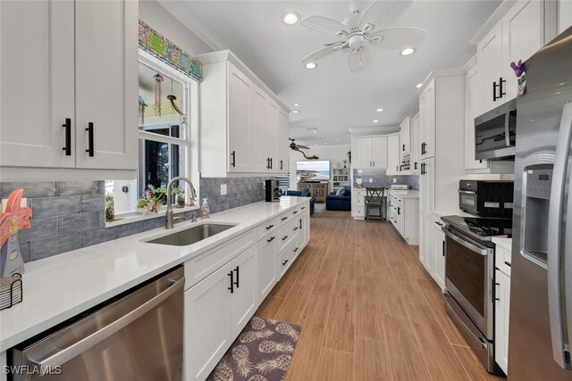 kitchen featuring white cabinets, appliances with stainless steel finishes, and sink