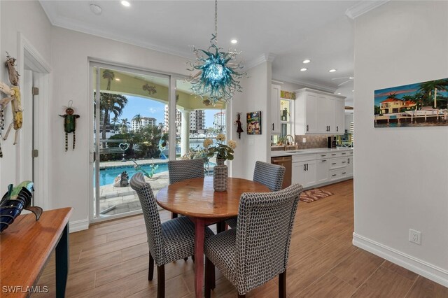 dining room with sink and ornamental molding