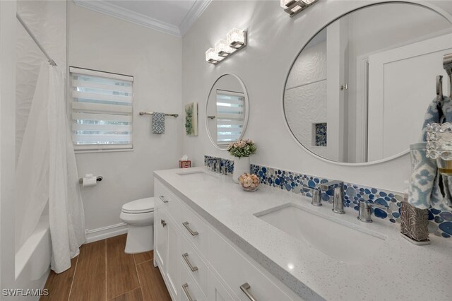 full bathroom with shower / tub combo, vanity, toilet, and crown molding