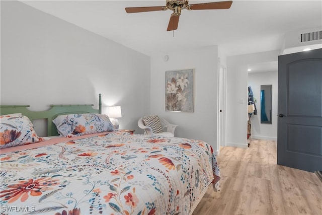 bedroom with ceiling fan and light hardwood / wood-style flooring