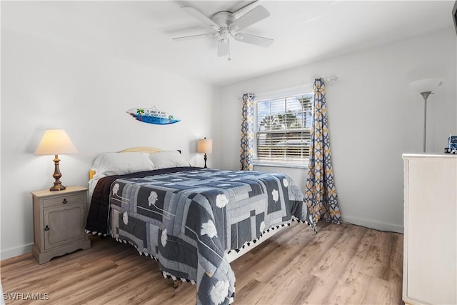 bedroom with ceiling fan and light hardwood / wood-style floors