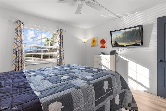 bedroom with ceiling fan and light hardwood / wood-style floors