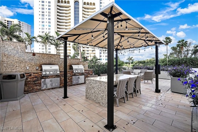 view of patio featuring area for grilling and a grill