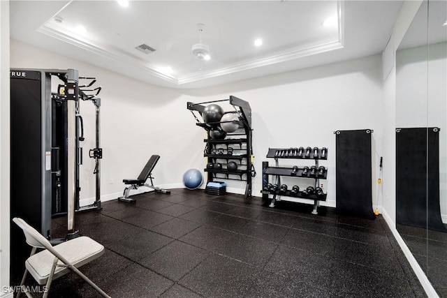 workout area featuring a tray ceiling