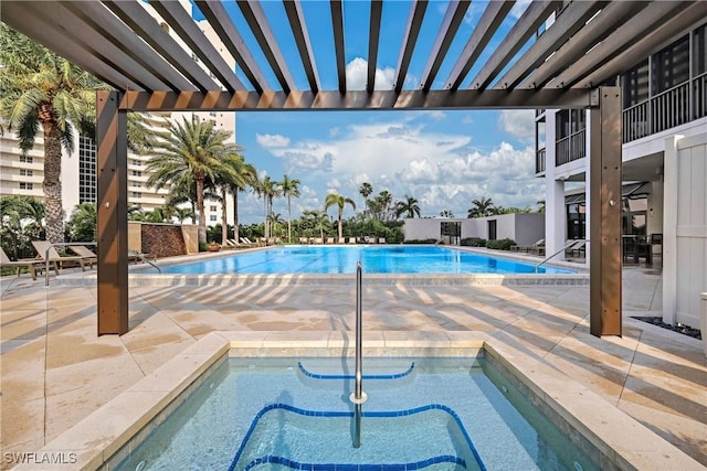 view of swimming pool featuring a pergola, a patio area, and a hot tub