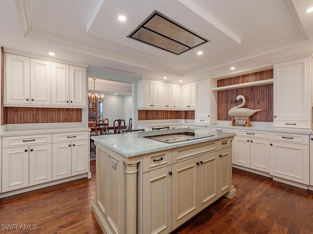 kitchen with black electric stovetop, dark hardwood / wood-style flooring, a kitchen island, and hanging light fixtures