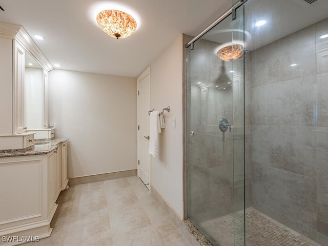 bathroom featuring vanity and a shower with shower door