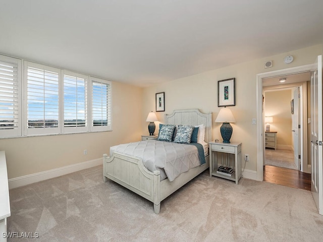 bedroom featuring light colored carpet