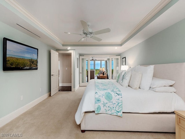 bedroom with access to exterior, ornamental molding, a tray ceiling, light colored carpet, and ceiling fan