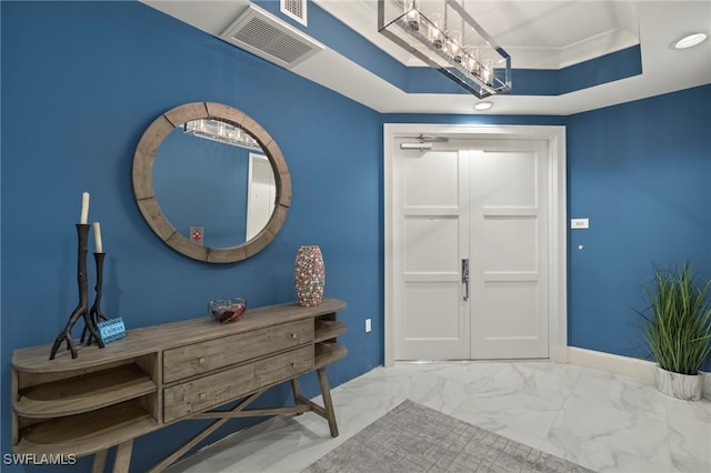 foyer entrance featuring a raised ceiling