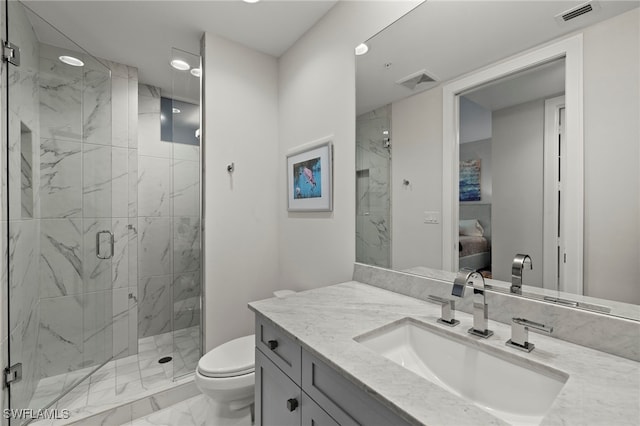 bathroom featuring vanity, an enclosed shower, and toilet