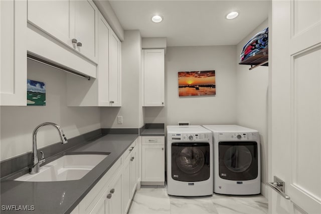 laundry area with sink, washer and clothes dryer, and cabinets