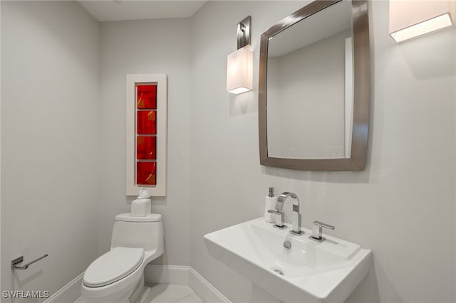 bathroom with sink, tile patterned floors, and toilet