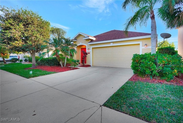 view of front of property with a garage and a front yard