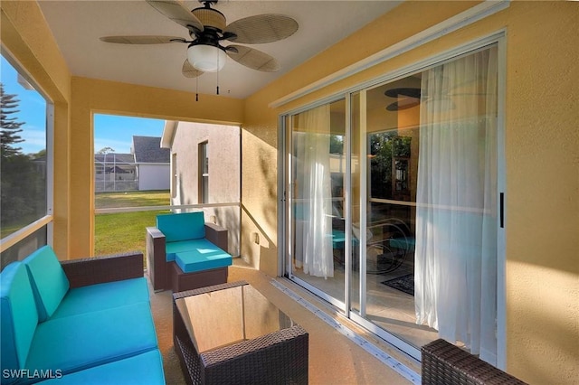 sunroom featuring ceiling fan