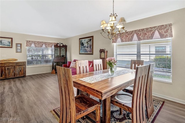 dining space featuring an inviting chandelier and hardwood / wood-style flooring