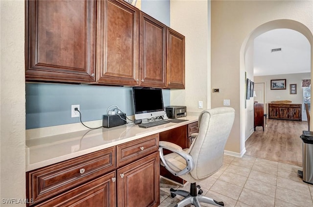 office featuring light tile patterned flooring and built in desk