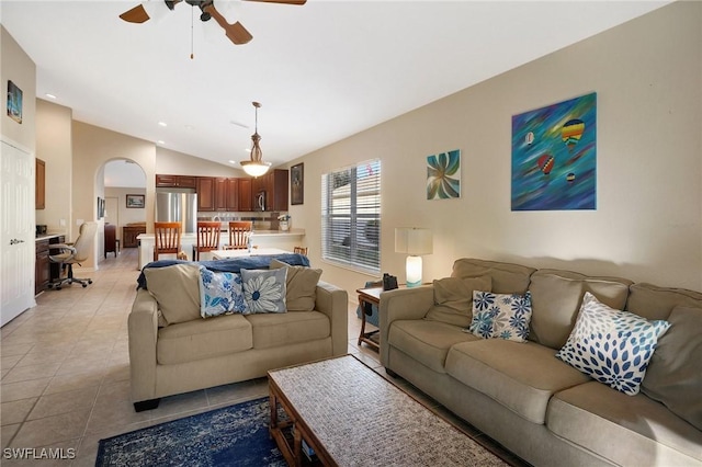 tiled living room with lofted ceiling and ceiling fan