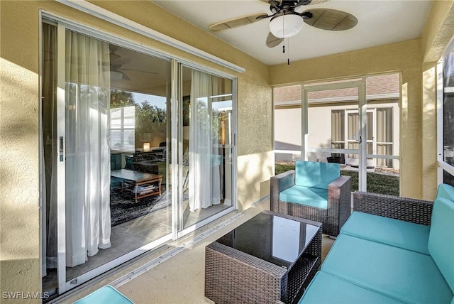 sunroom / solarium featuring ceiling fan