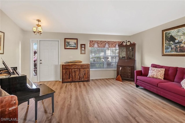 living room with a notable chandelier and light hardwood / wood-style floors