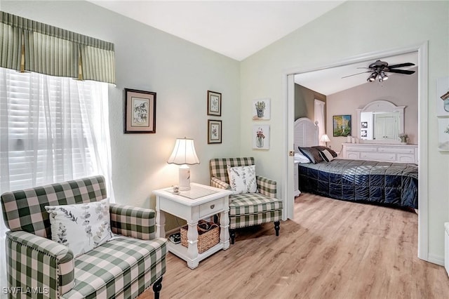 sitting room featuring ceiling fan, plenty of natural light, lofted ceiling, and light wood-type flooring