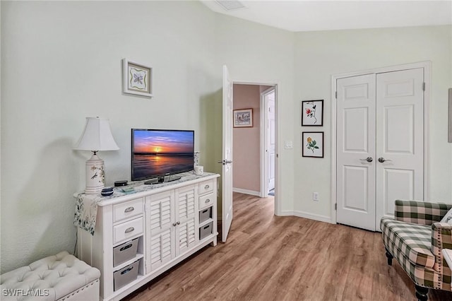 interior space with lofted ceiling and light hardwood / wood-style floors