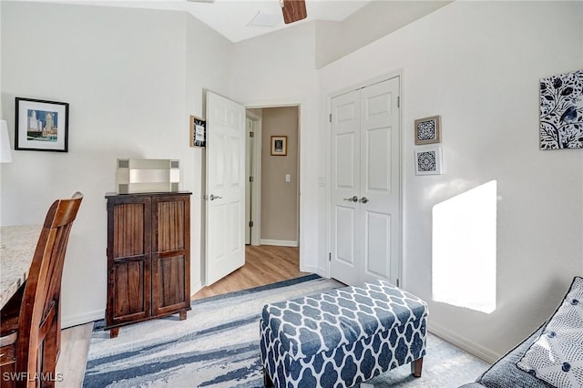 bedroom with light hardwood / wood-style flooring, a closet, and ceiling fan