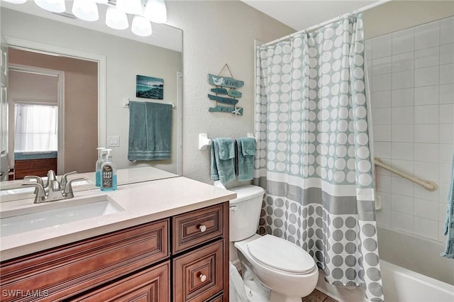 full bathroom featuring shower / tub combo, vanity, and toilet