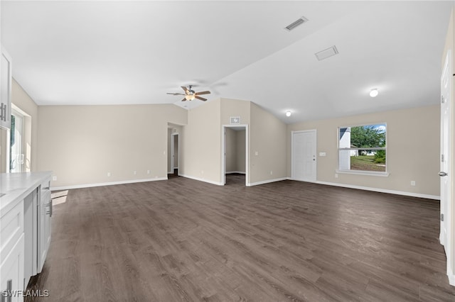 unfurnished living room with dark hardwood / wood-style flooring, ceiling fan, and lofted ceiling