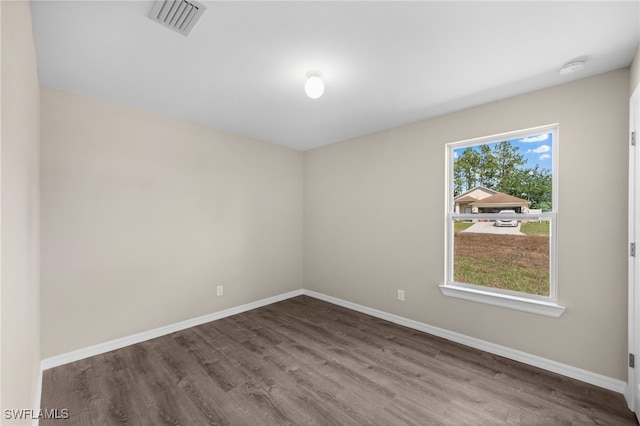 unfurnished room with hardwood / wood-style floors and a wealth of natural light