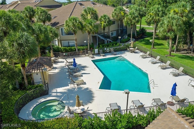 view of pool with a community hot tub and a patio area