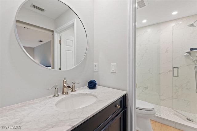 bathroom featuring toilet, vanity, wood-type flooring, and walk in shower