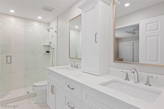 bathroom featuring vanity, toilet, and a shower with shower door