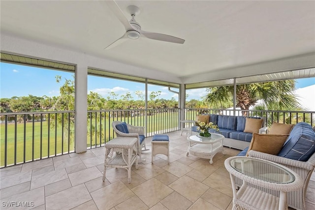 sunroom featuring ceiling fan