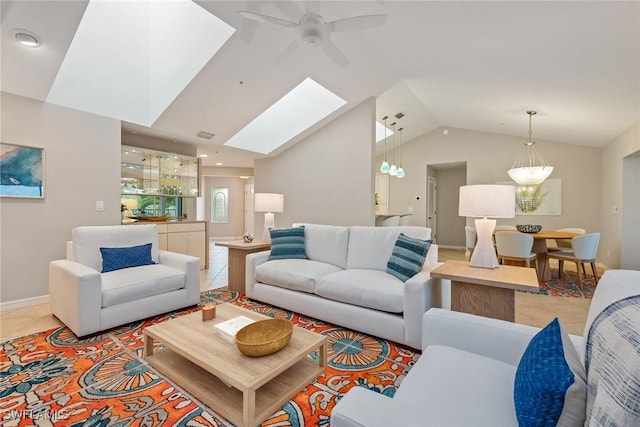 living room with ceiling fan and lofted ceiling with skylight