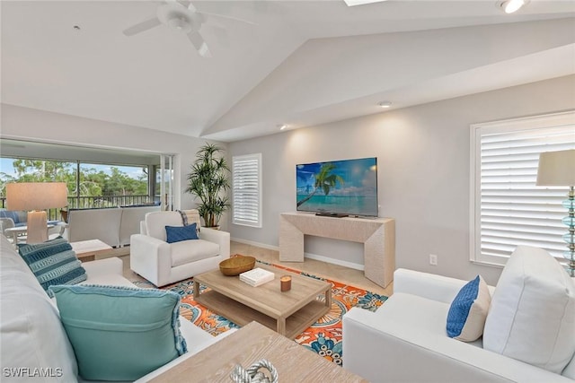 living room with ceiling fan and vaulted ceiling