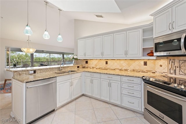 kitchen with sink, stainless steel appliances, tasteful backsplash, light stone counters, and pendant lighting