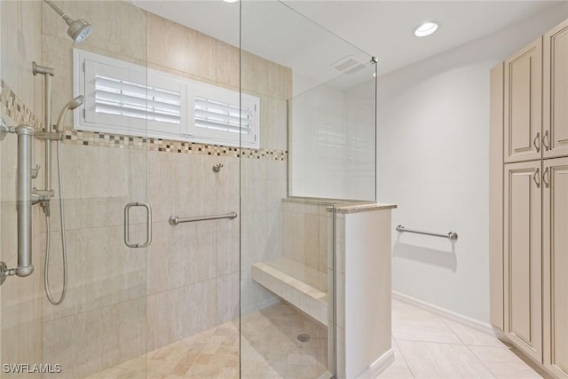 bathroom with tile patterned flooring and an enclosed shower