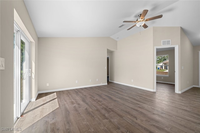 unfurnished living room with dark hardwood / wood-style floors, vaulted ceiling, plenty of natural light, and ceiling fan