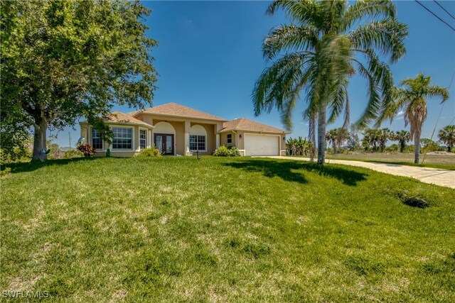 view of front of house featuring a front lawn and a garage